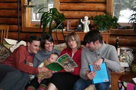 Mom reads to us all from Snipp, Snapp, Snurr and the Yellow Sled.
